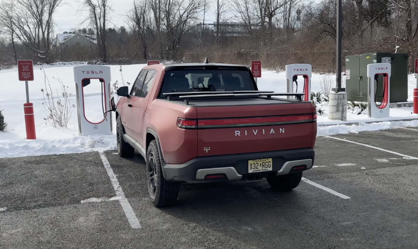 A Rivian R1T charges on a Tesla supercharger in Upstate New York