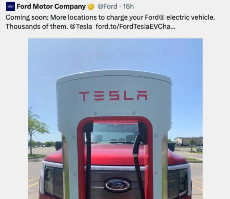 A tweet from Ford Motor Company announcing more locations to charge Ford electric vehicles at Tesla stations. A Ford vehicle is shown at a Tesla charging station.